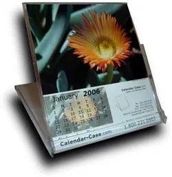 A desk calendar displaying January 2006 with an orange flower photo on top.