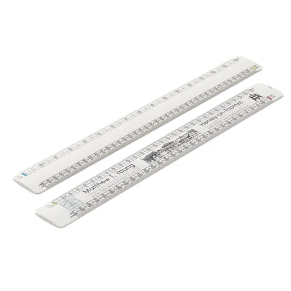 Two white plastic rulers with printed scales and black building illustrations.
