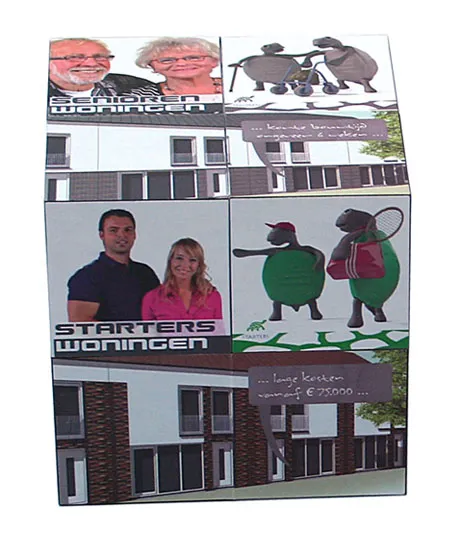 A cube features photos of houses, cartoon sheep, and two pairs of people in different panels.