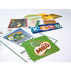 Assorted colorful stickers and cards scattered on a white surface.