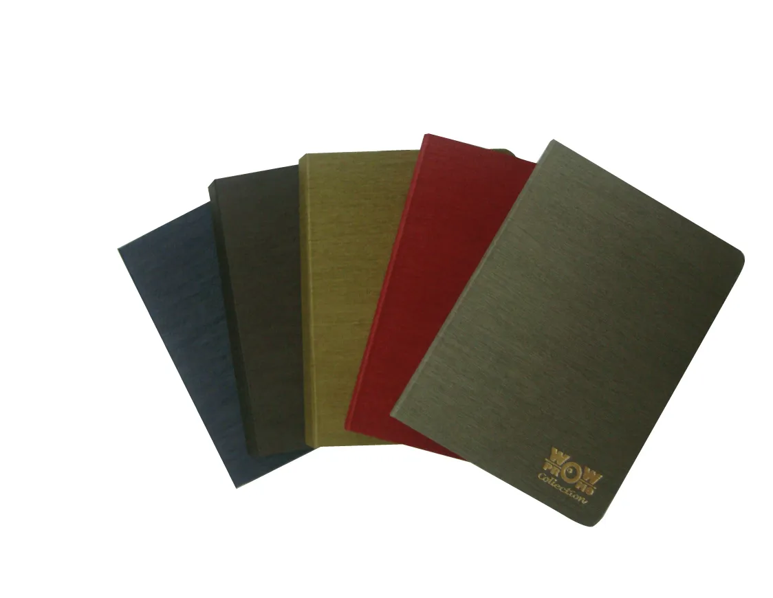 7a924e3f67ec42757caa538feccdeea1_1 Four fabric-covered notebooks in blue, brown, yellow, red, and gray, fanned out.