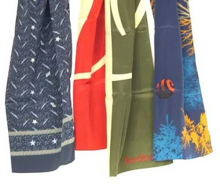 Four colorful patterned fabrics hanging side by side, each with different designs.