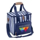 A striped blue and white cooler bag with a front pocket displaying a colorful geometric logo and the text WOOD GROUP. It has a brown handle and a shoulder strap, with a small zipper pocket featuring a light brown zipper.