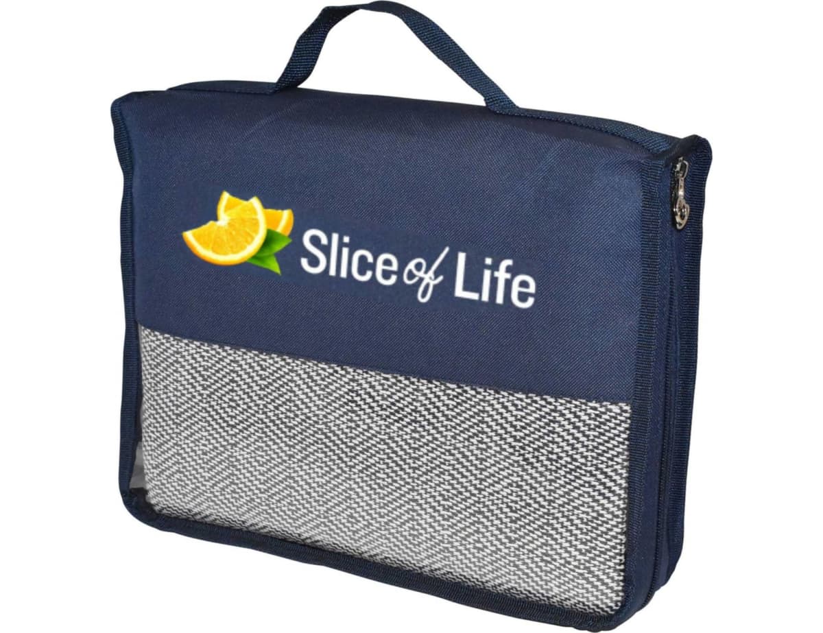 b4808_noosa_deluxe_picnic-1 A navy blue carrying case with a handle and zippered closure. Slice of Life is printed on it along with an image of an orange slice. The lower part features a mesh pocket.