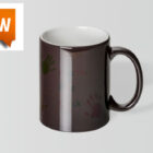 Black coffee mug with faint handprints and a new label in the top left corner.