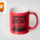 Red mug with an ambulance photo printed on it; new label in top left corner.