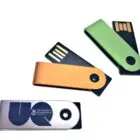 Three USB flash drives with metal swivel covers in silver, orange, and green colors.