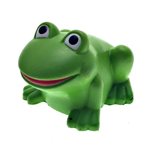 A green toy frog with big eyes and a smiling mouth on a white background.