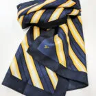 Navy blue scarf with yellow and white diagonal stripes, folded on a white surface.