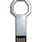 A USB flash drive shaped like a key, with a metallic finish, on a white background.