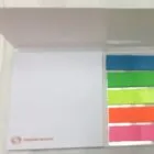 Open notepad with sticky notes in blue, green, yellow, orange, and pink on the right side.