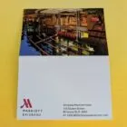 Marriott Brisbane hotel card on a yellow surface, featuring hotel details and a building photo.