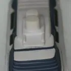 Toy model of a white and blue ship viewed from above on a plain background.