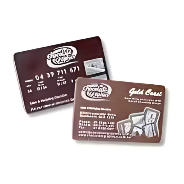 A stylized illustration of two sleek, business card-sized chocolates. Embossed details resemble card numbers and logos, with sketches of a man in a suit. The text reads Business Card Sized Chocolates and Gold Card.