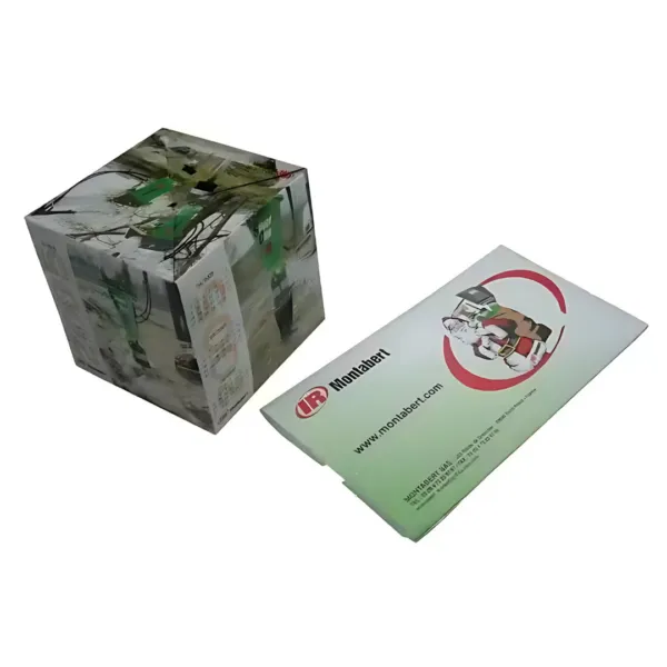 A transparent Paper Pop Up Cube Fab Mailer with an abstract design sits beside a rectangular package featuring robotic arm illustrations, labeled Monahart with a website URL.