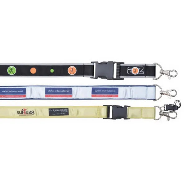 Displayed are three Poly/Satin Lanyard-inspired dog leashes: the top in black with colorful circles, the middle in white with blue accents, and the bottom in beige with a black label. Each leash includes a metal clasp and adjustable strap for convenience.