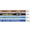 Four colorful satin lanyards, each with a metal clip, display different texts: brown with LUUN SULVEST, black with aus&raus, light blue with Neustadt an der Orla, and dark blue with STAND YE IN HOLY PLACES. Perfect for adding a touch of style to your accessories.