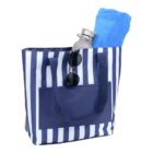 Blue and white striped tote bag with a blue towel, water bottle, and sunglasses inside.