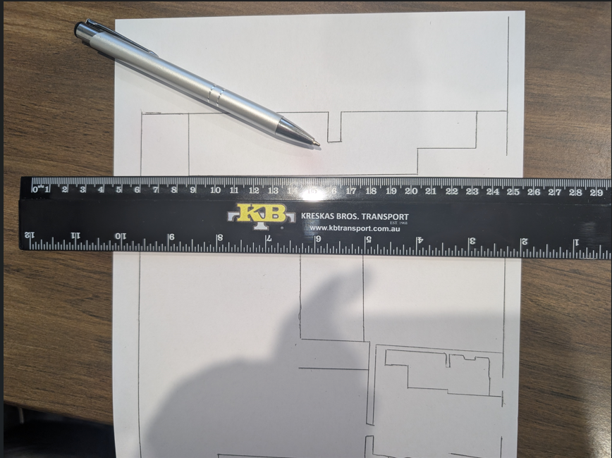 A ruler and pen on paper with KB Transport floor plan sketches in Sunshine West.
