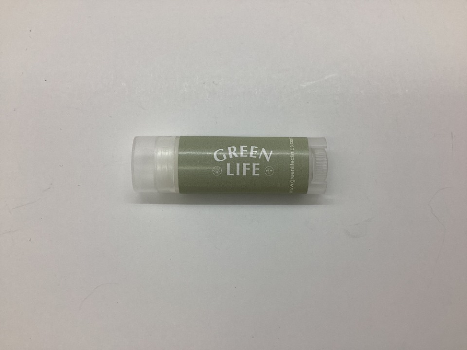 A tube of GREEN LIFE lip balm, one of our top reordered wellness items, on a white background.